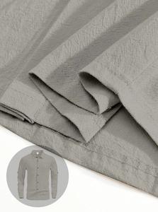 Detail of grey linen shirt fabric texture with high-quality stitching and pocket