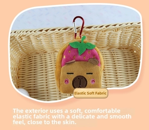 Detail of Capybara plush bag with strawberry hat made of elastic soft fabric