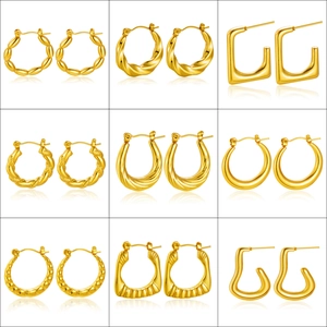 Collection of nine various golden stainless steel hoop earrings in polished finish