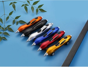 Set of six colorful car-shaped ballpoint pens with realistic wheels on blue background