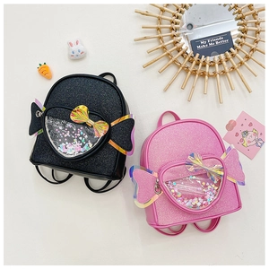 Close-up of glitter school bag featuring a candy-shaped pocket filled with colorful sequins