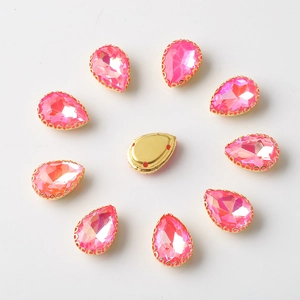 Detailed view of 10x14mm pink teardrop rhinestones with gold sew-on claw settings