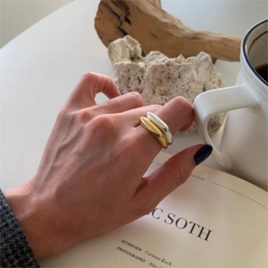Minimalist gold and silver chunky ring set styled on model in lifestyle setting
