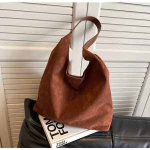 Brown faux suede hobo shoulder bag with a minimalist slouchy design on a white background