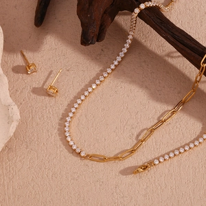Detail of 18K gold-plated jewelry set with pavé zircon and paperclip chain links