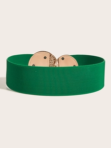 Macro shot of green elastic wide waist belt with elegant gold metal buckle detail