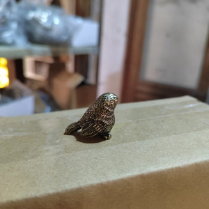 Solid brass bird figurine with vintage bronze finish and detailed feather carvings