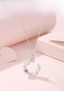 Detailed close-up of S925 silver moon wreath pendant necklace with pink crystals