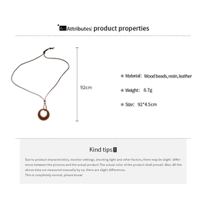 Detail view of round wood and resin pendant necklace with product dimensions and specs