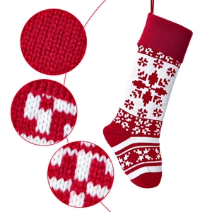 Detail of red knit Christmas stocking showing snowflake jacquard and hanging loop