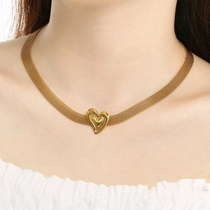 Golden mesh chain necklace featuring a 3D heart pendant worn by a model