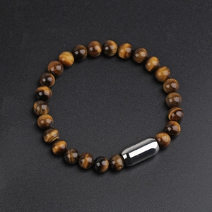 Detailed view of 8mm yellow tiger eye stone beaded bracelet with steel clasp on black background
