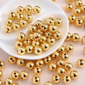 Macro shot of polished gold plated round acrylic beads for DIY jewelry making