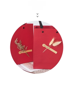 Detail of red gift bag with dried flowers and Especially for you golden label