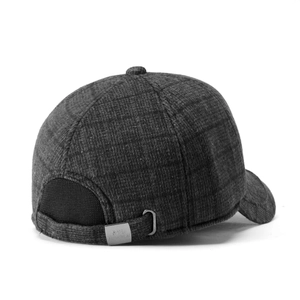 Close-up of grey plaid wool baseball cap with metal buckle and fabric texture details