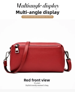 Front view of a red lychee texture genuine leather crossbody bag with silver zippers