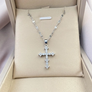 Classic silver plated cross necklace with sparkling cubic zirconia on a beige fabric box