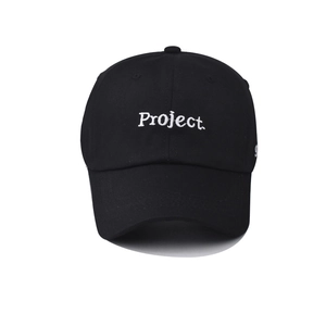 Detail of white Project letter embroidery and number 9 on a black cotton baseball cap