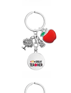 Close-up of teacher gift keychain with apple, tree of life, and owl charms