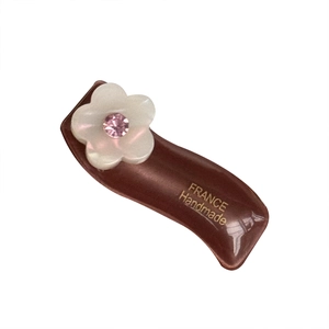 Elegant tortoiseshell acetate flower hair clip with white petals and pink crystal center