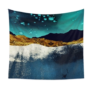 Macro detail of abstract mountain tapestry with golden texture and blue hues