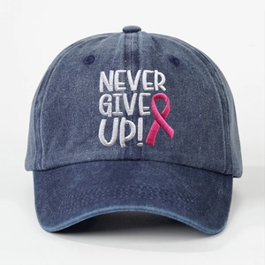 Front view of washed navy baseball cap with NEVER GIVE UP embroidery and pink ribbon