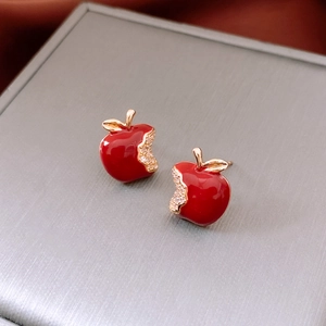 Detail of red enamel apple earring with leaf and crystal pavé on golden base