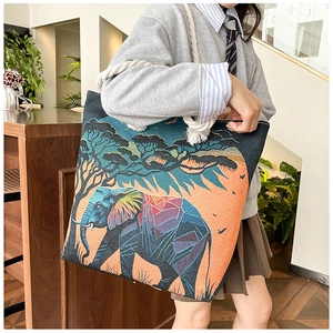 Detailed view of the elephant jacquard pattern and thick cotton rope handles on tote bag