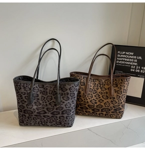 Detail view of large leopard print tote bags in grey and brown textured canvas fabrics