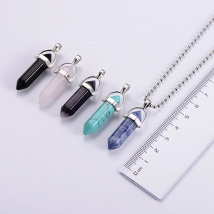 Hexagonal gemstone pendant necklaces with metal ball chains shown with a ruler for size