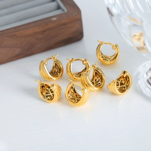 Vintage 18K gold plated U-shaped hoop earrings with striped texture and cutout patterns