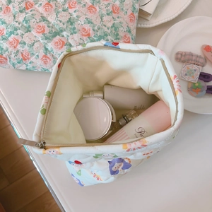 Detail view of floral quilted cotton makeup bag with interior cosmetic storage space