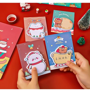 Close-up of cute Christmas themed sticky notes featuring cartoon bears and snowmen