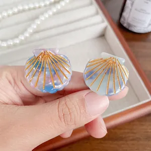 Pearlescent shell hair clips with golden lines in blue and pink tones, set of two