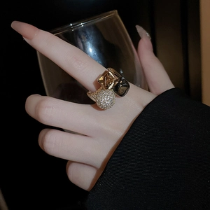 Detail shot of vintage gold-plated open ring with champagne and smoke grey crystals