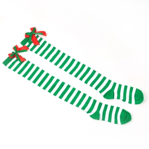 Close-up of green and white striped Christmas over-knee socks with red ribbon bows