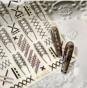 Detail of 3D nail art stickers M-1011 featuring black cross lines and golden dots