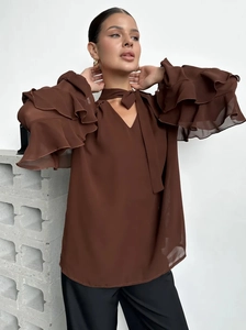 Brown chiffon blouse with ruffled flare sleeves and neck tie detail on a model