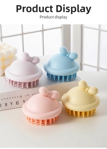 Close-up of four colorful silicone scalp massagers with cute bow handles on a sunny windowsill