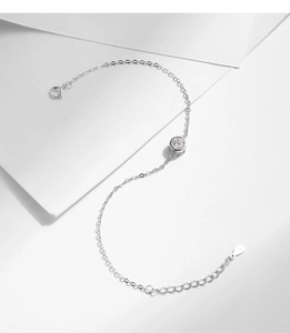 Close-up of S925 sterling silver bracelet detailing lobster clasp and hallmark tag