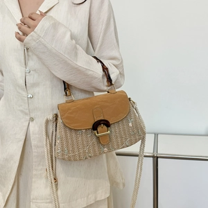Retro straw handbag with bamboo handle and embroidery detail shown in a model shot