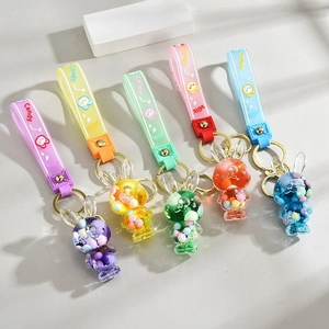 Detail of colorful acrylic liquid quicksand rabbit keychains with soft rubber straps