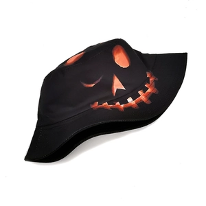 Detail of double-sided Halloween bucket hat with glowing orange pumpkin face print