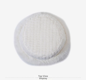 Top view of white plush bucket hat showing circular crown and textured stitching detail