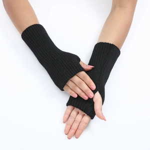 Close-up of black striped knit fingerless gloves showing wrist length and texture