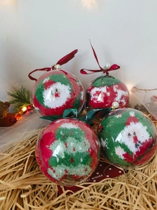 Detailed view of plush Christmas socks set in transparent ball packaging with festive lights