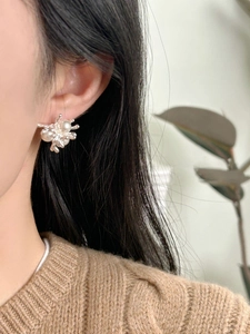 Detailed view of silver French vintage pearl earrings on model highlighting the design