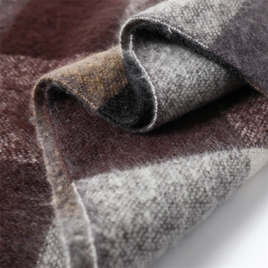 Close-up of soft brushed cashmere-feel fabric with brown and grey plaid pattern
