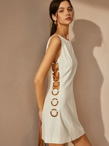 White sleeveless dress featuring side cut-outs and amber ring accents in a slim fit style