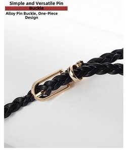 Detail of a black woven belt with a solid gold alloy pin buckle and seamless finish
